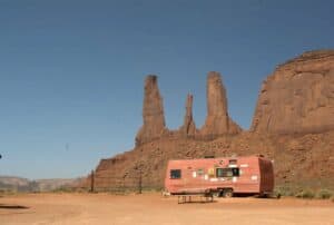Near the iconic sandstone towers in Monument Valley, a concession trailer offers food, with a picnic table out front.